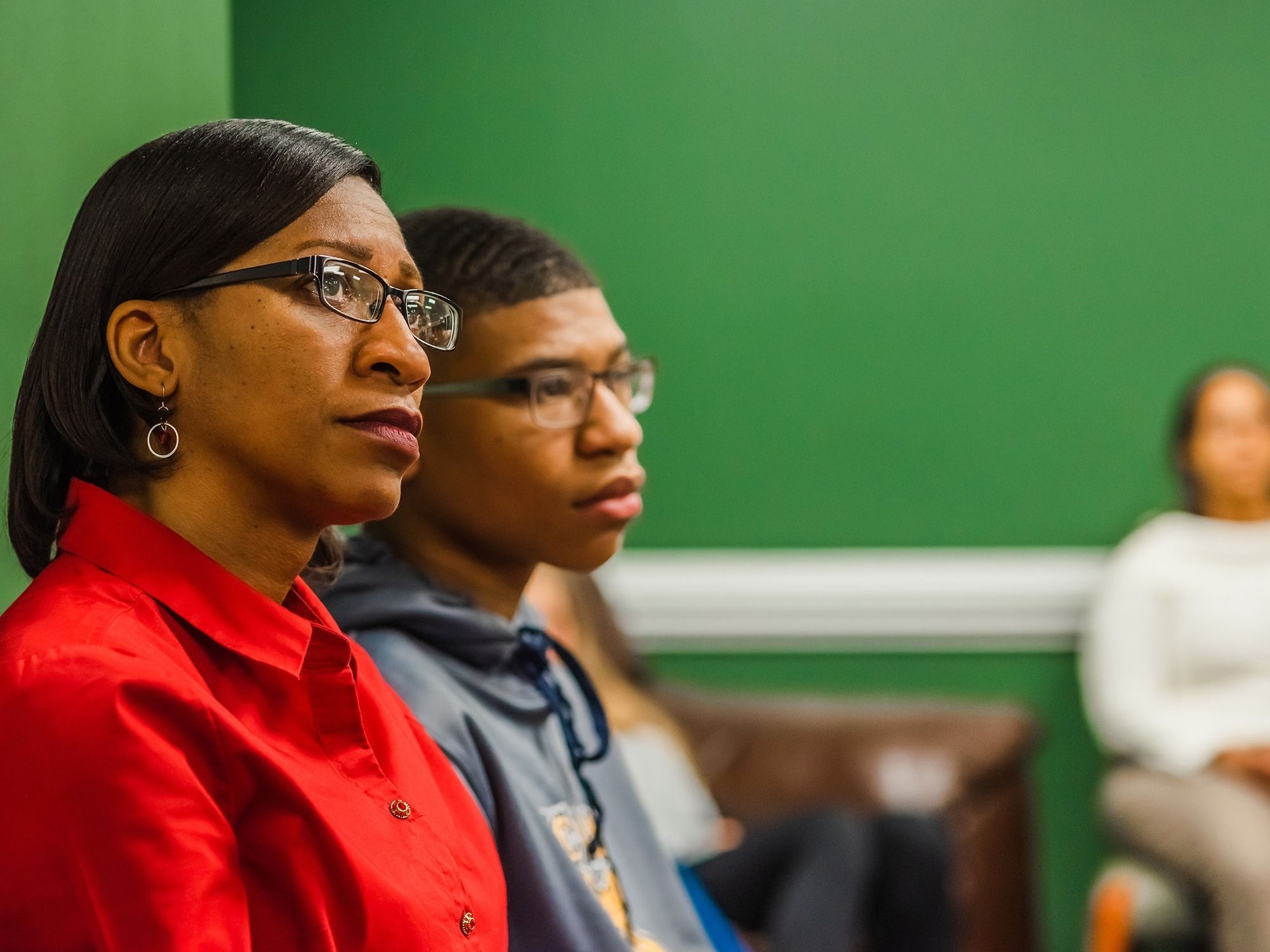 A woman and her son attend a focus group meeting.