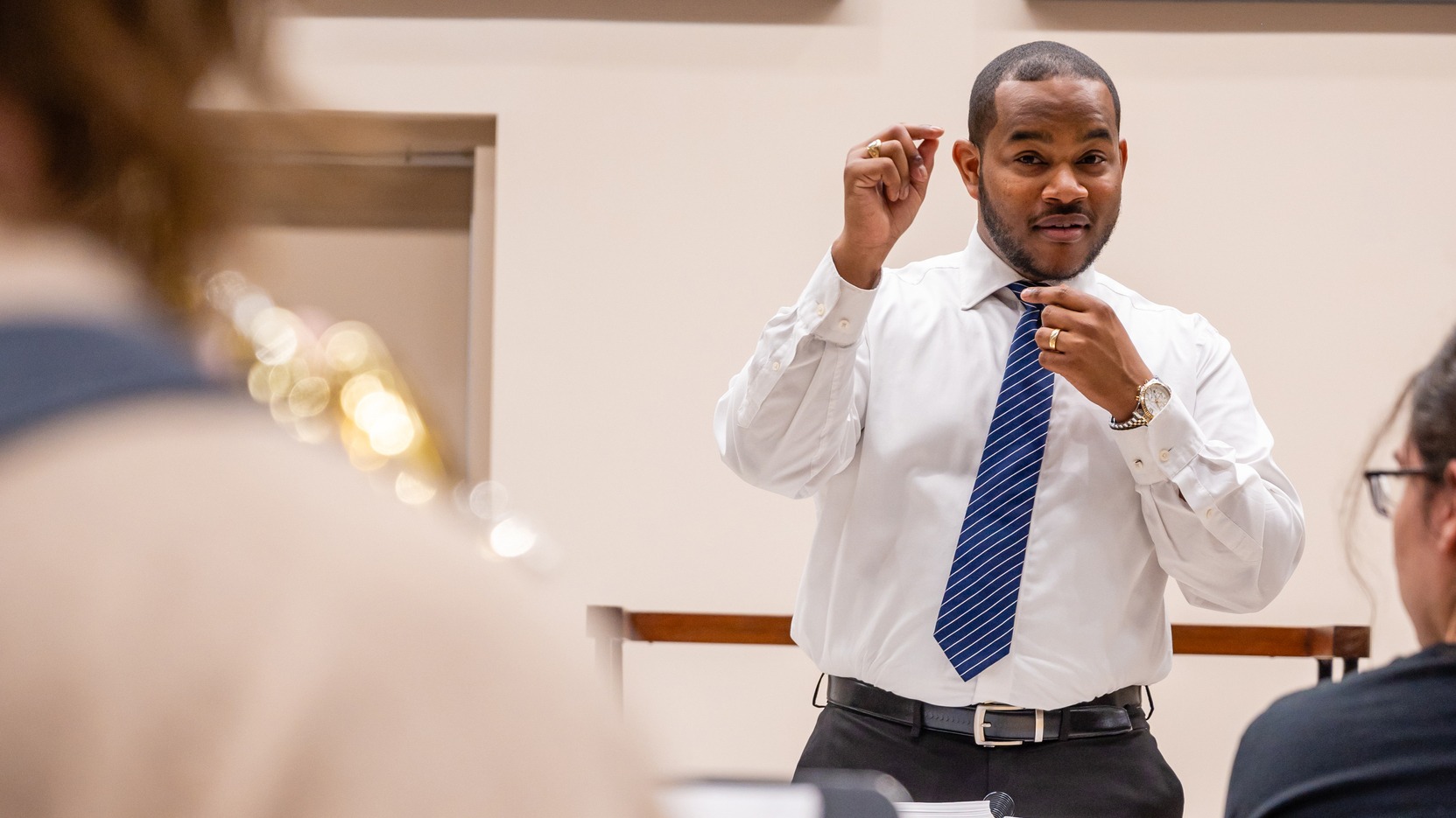a person in a white shirt and blue tie