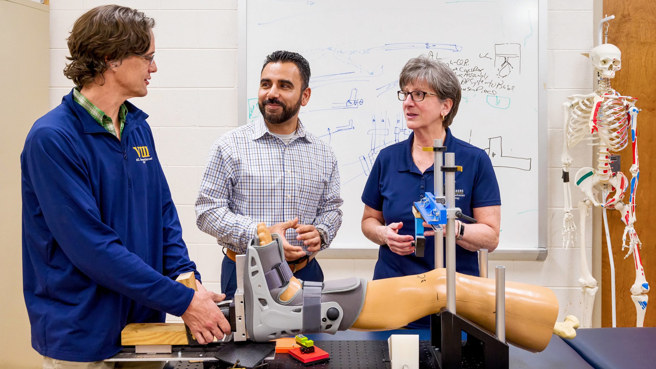 a group of people standing around a prosthetic leg