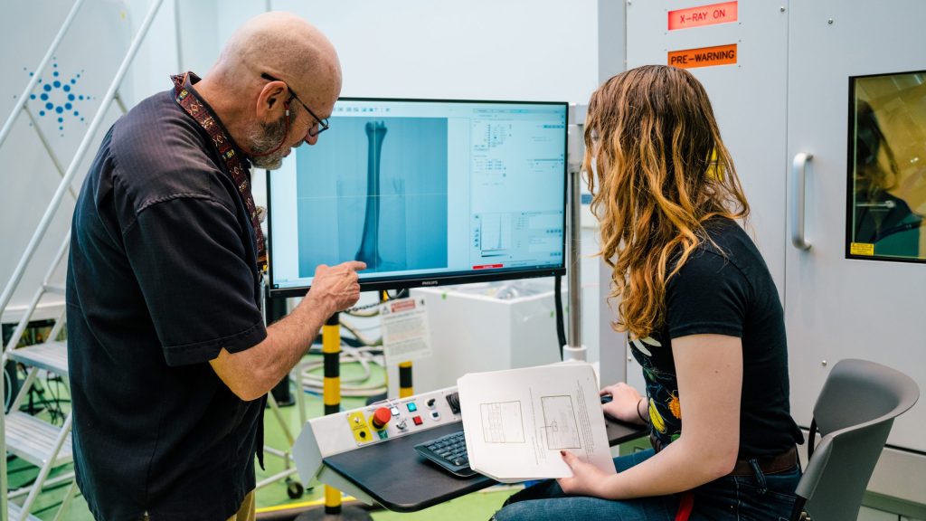 Two people looking at a computer monitor