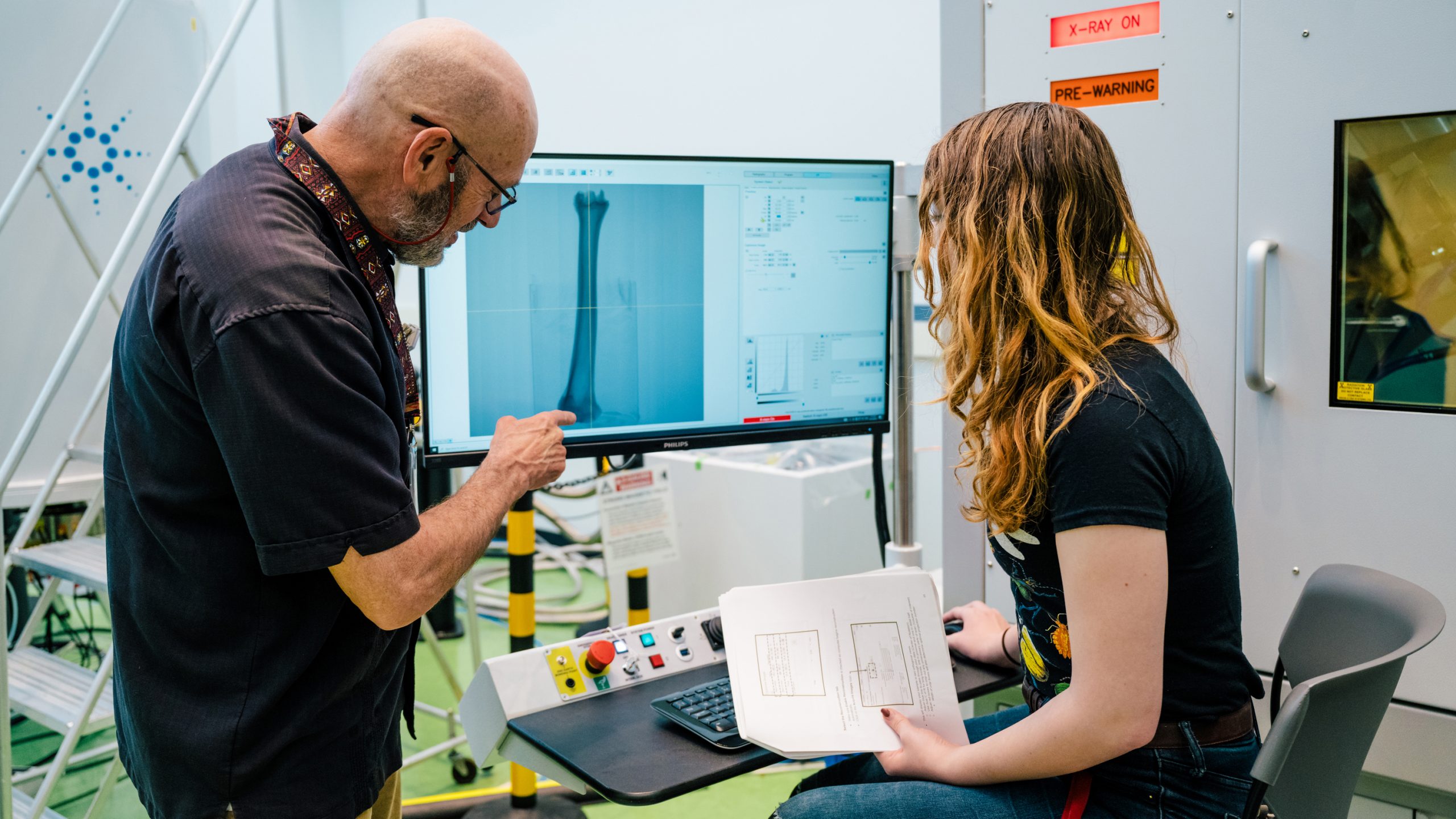 Two people looking at a computer monitor