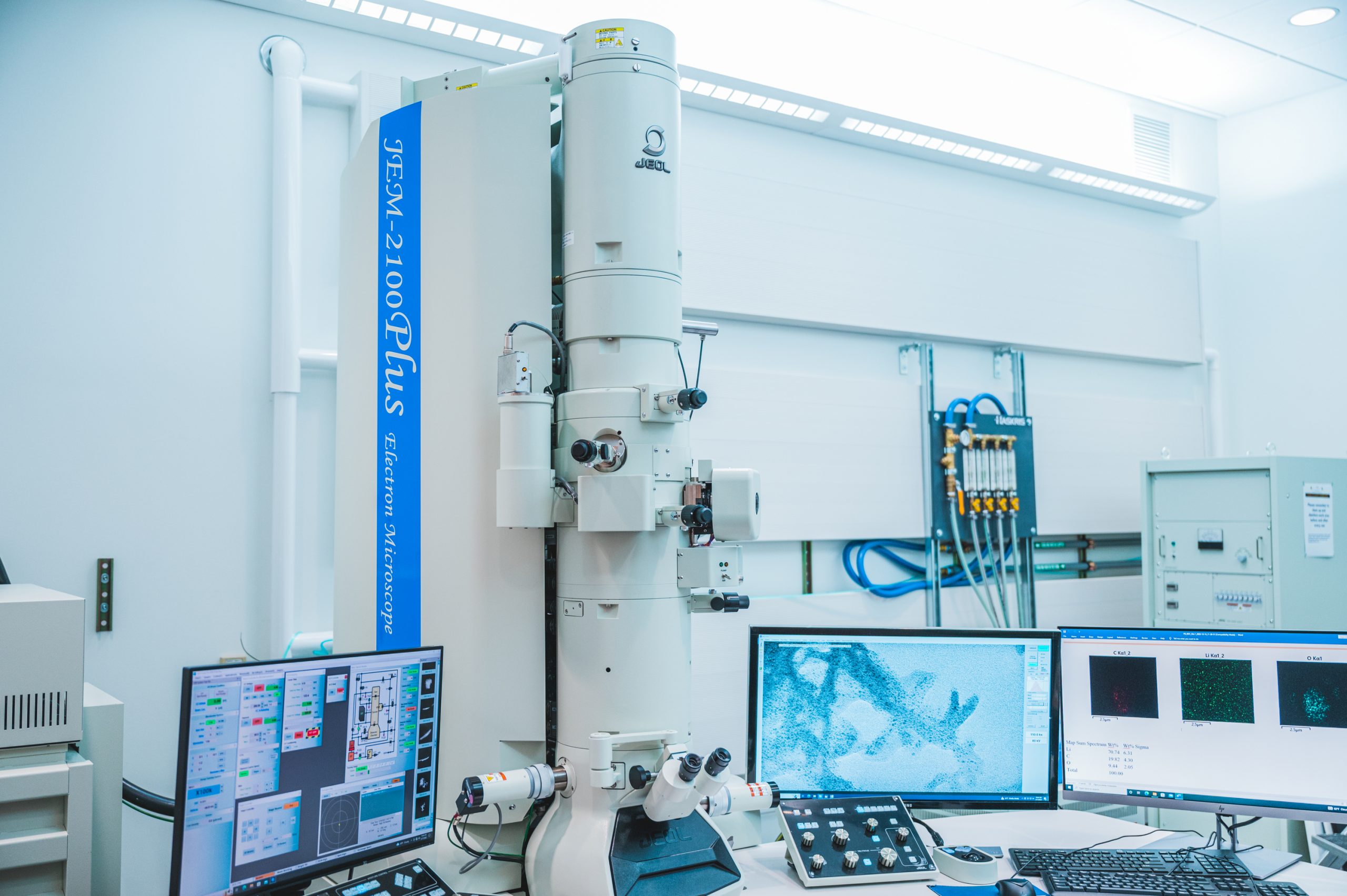 several computer monitors and machines in a lab