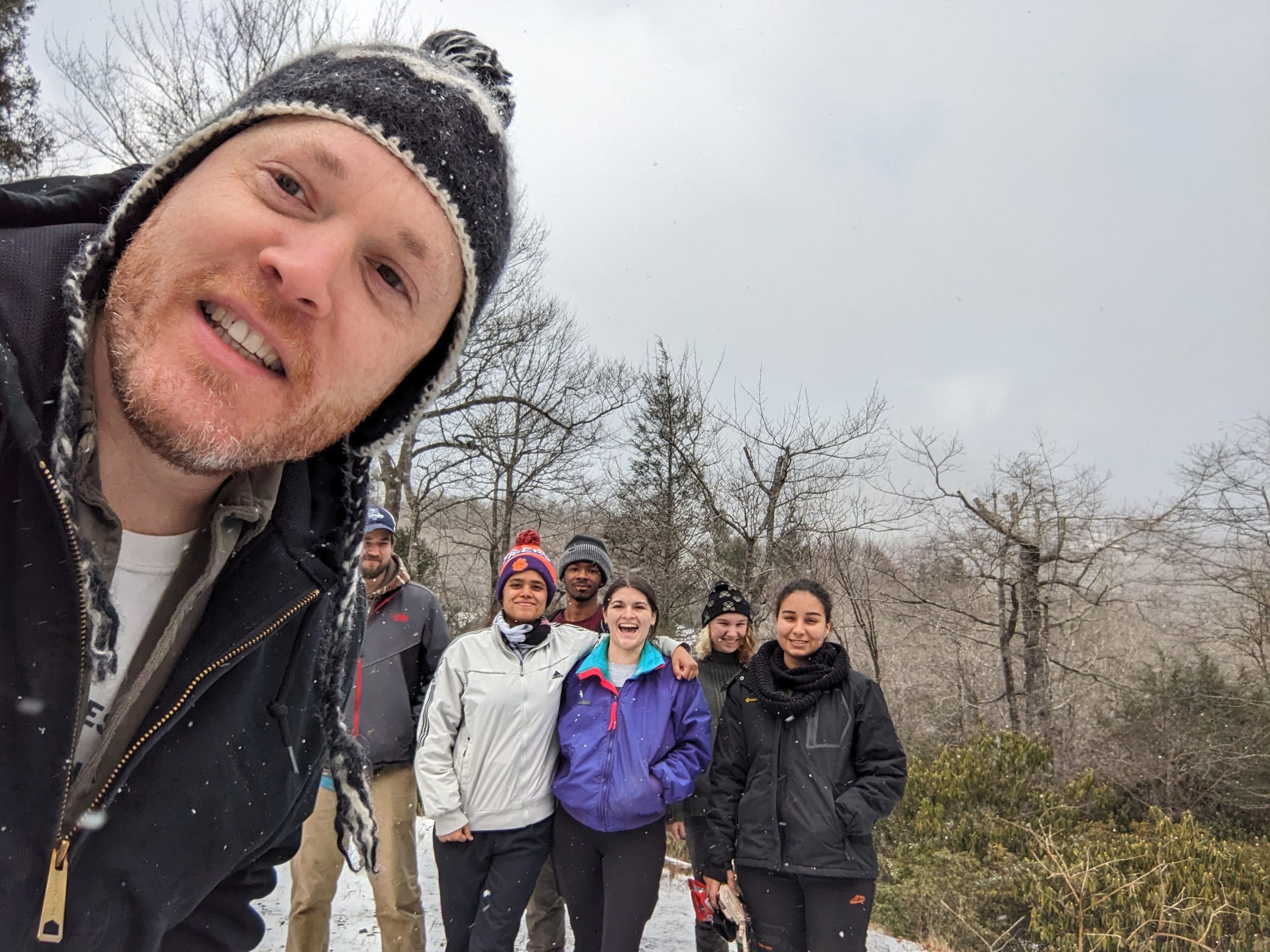a group of people standing in the snow