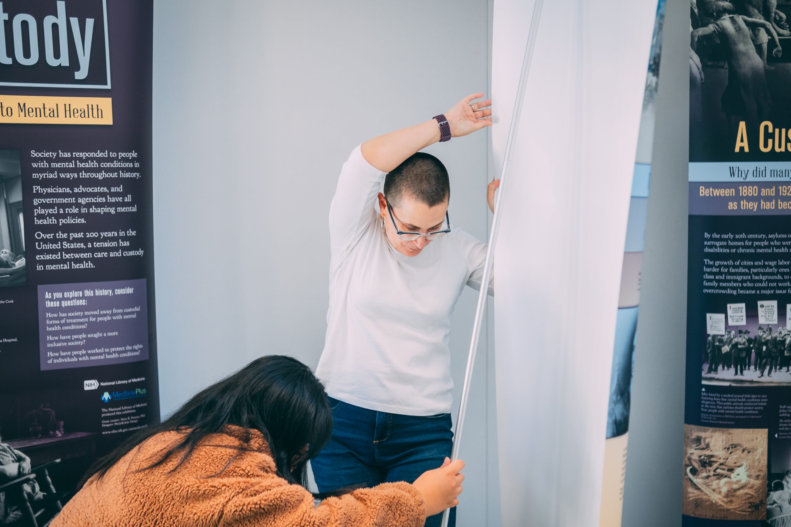 Parsons and student setting up traveling exhibit