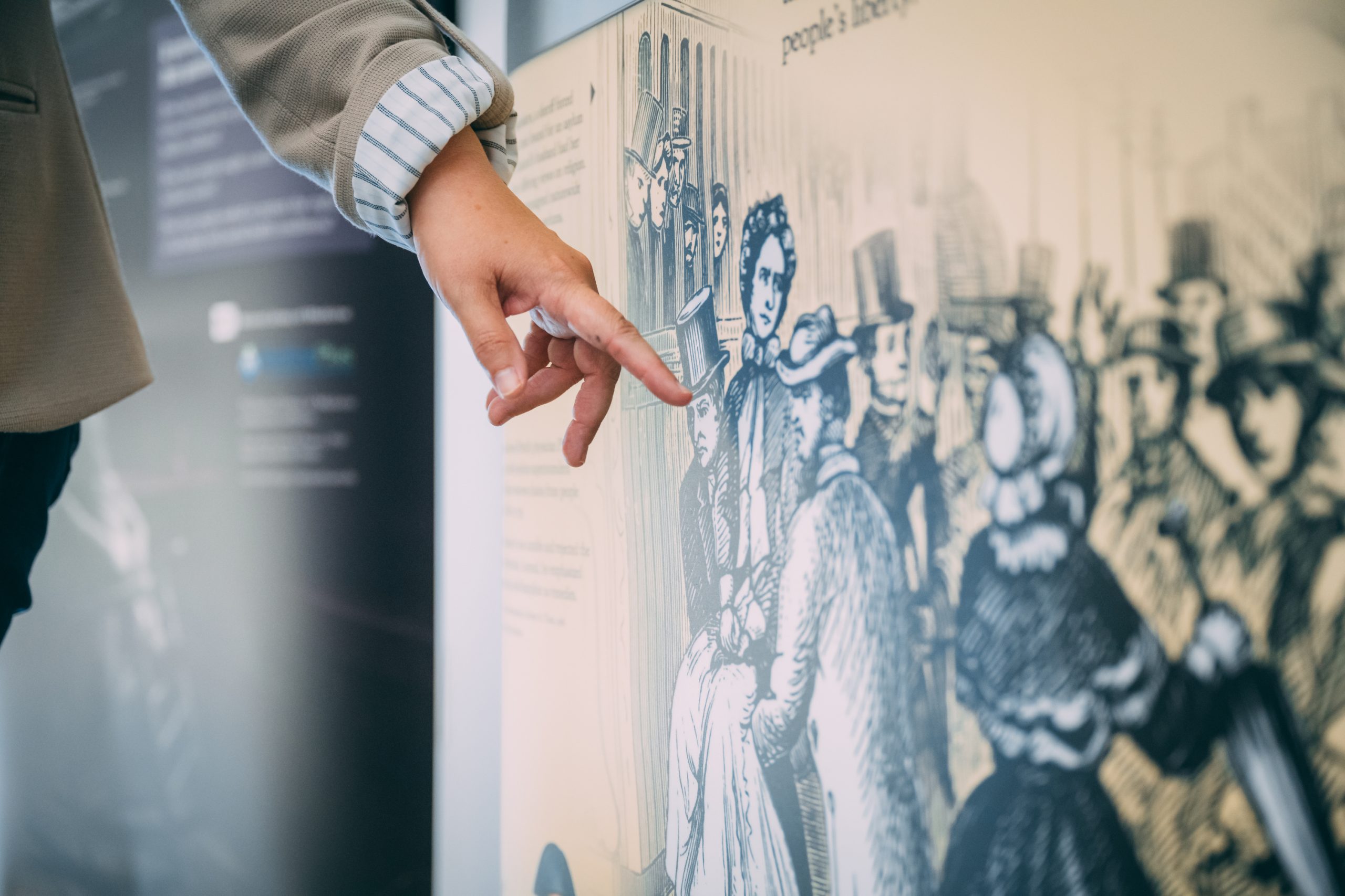 Parsons pointing to a detail in the Care and Custody traveling exhibit