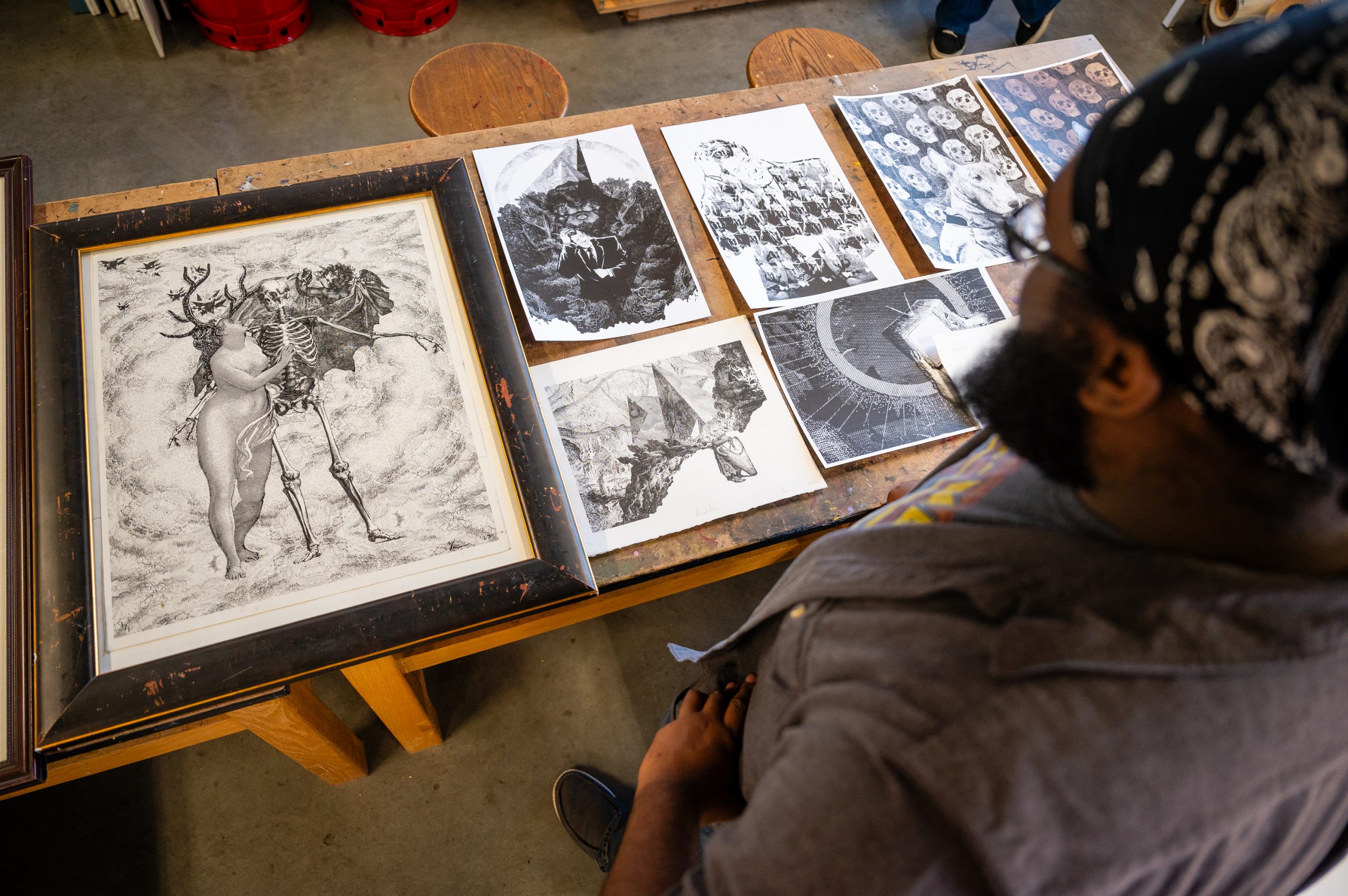Miles-Moultrie standing over some of his prints