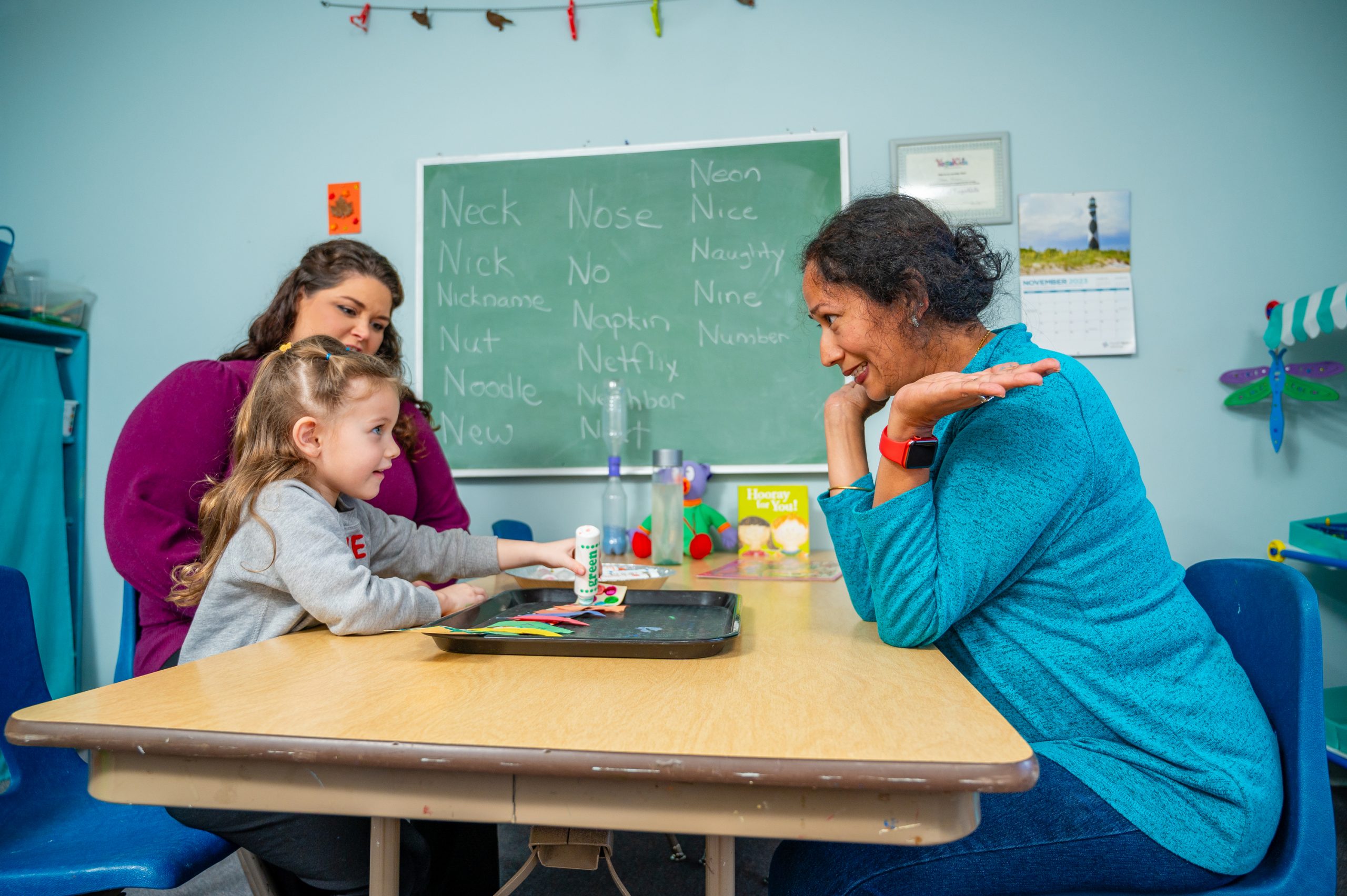 Ramesh with student and teacher at KinderNest Preschool