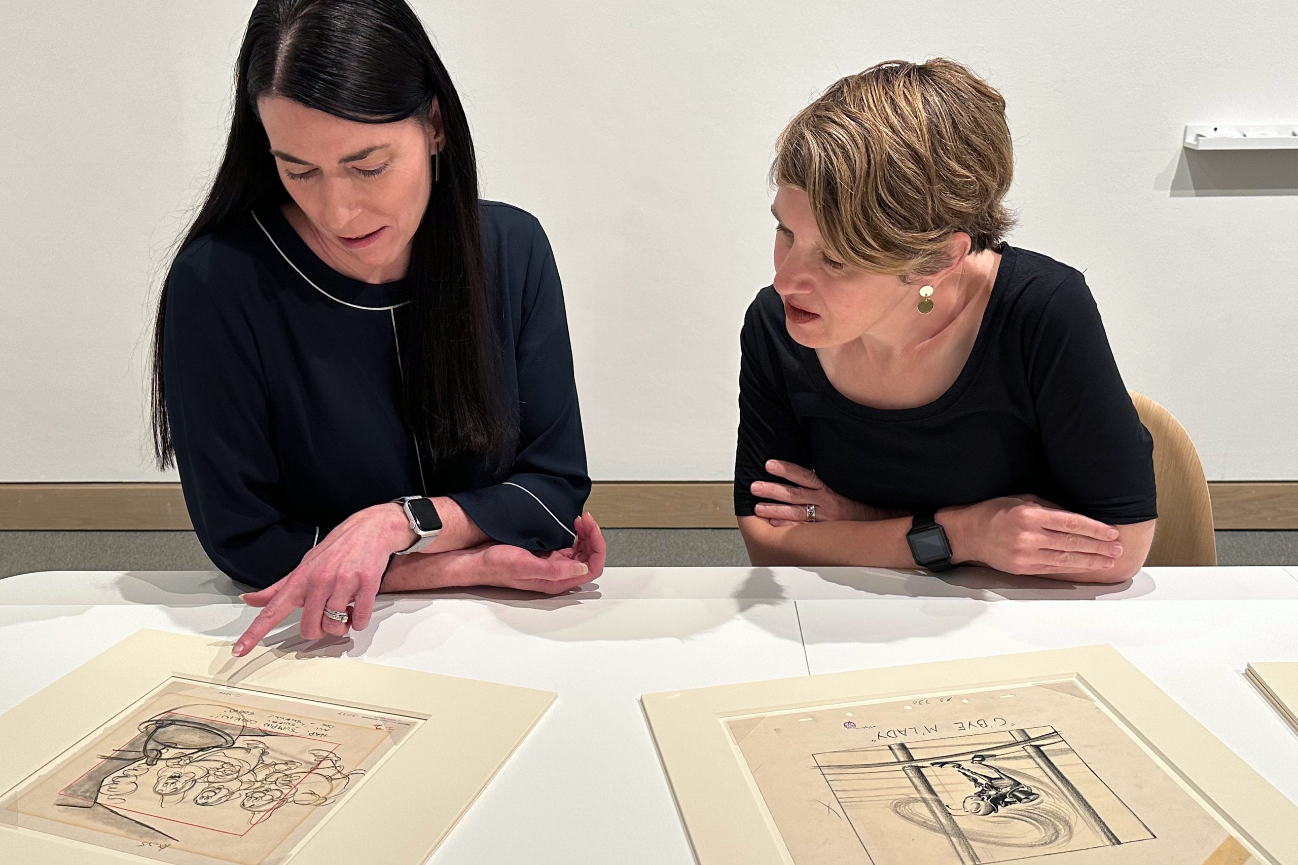 Heather Holian pointing out details in Disney animation to Emily Stamey