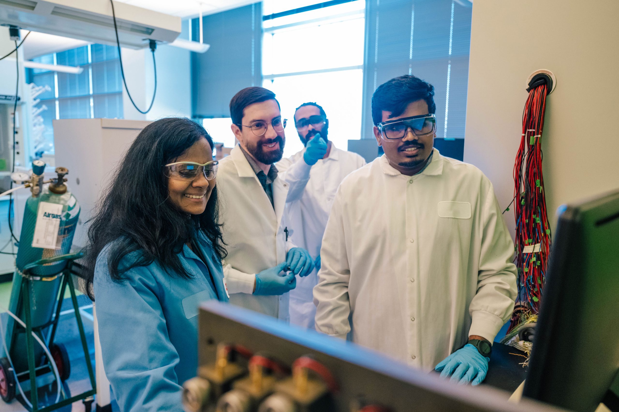 Wideman next to the Bod Pod, a machine that takes measurements of a child's body
